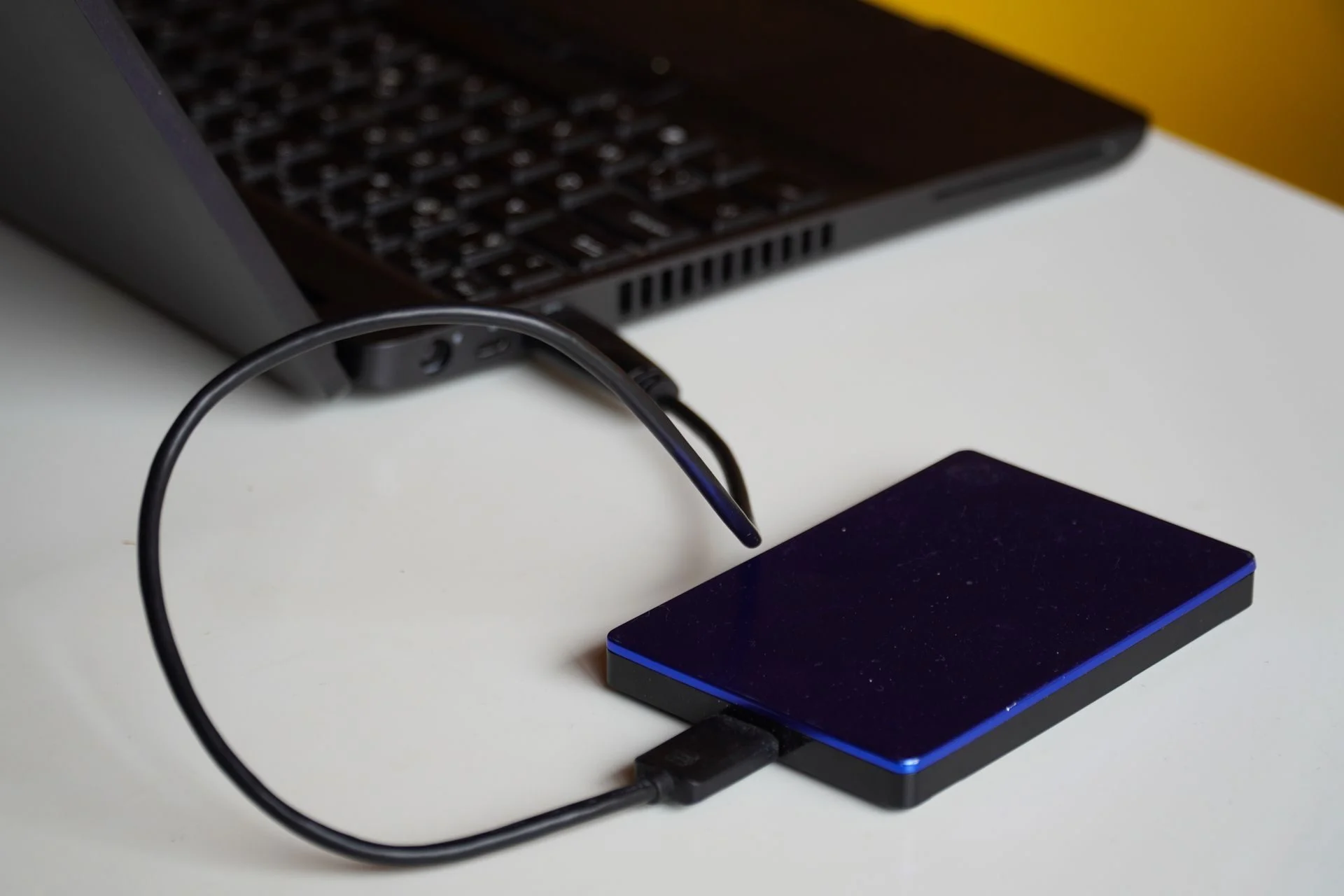 An external backup drive connected to a laptop
