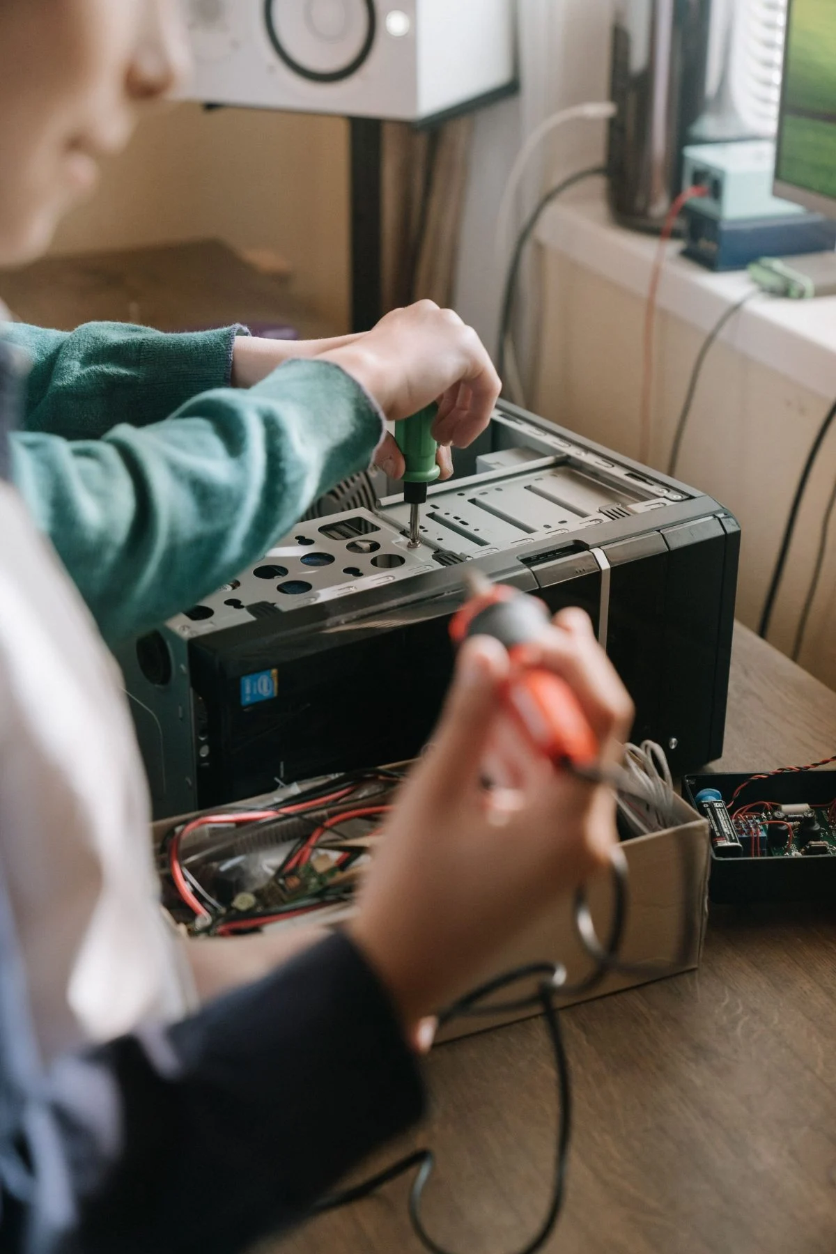 A technician working inside a desktop computer